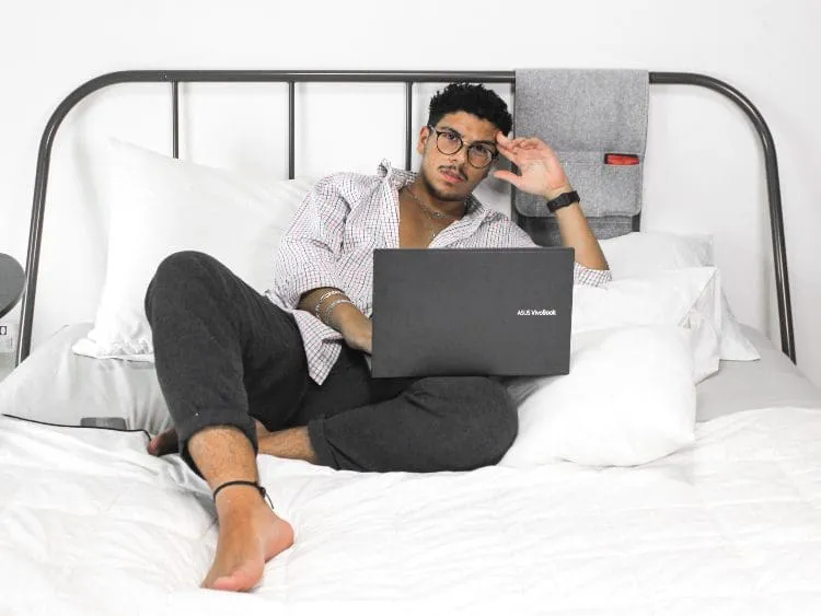 person working on a laptop in bed