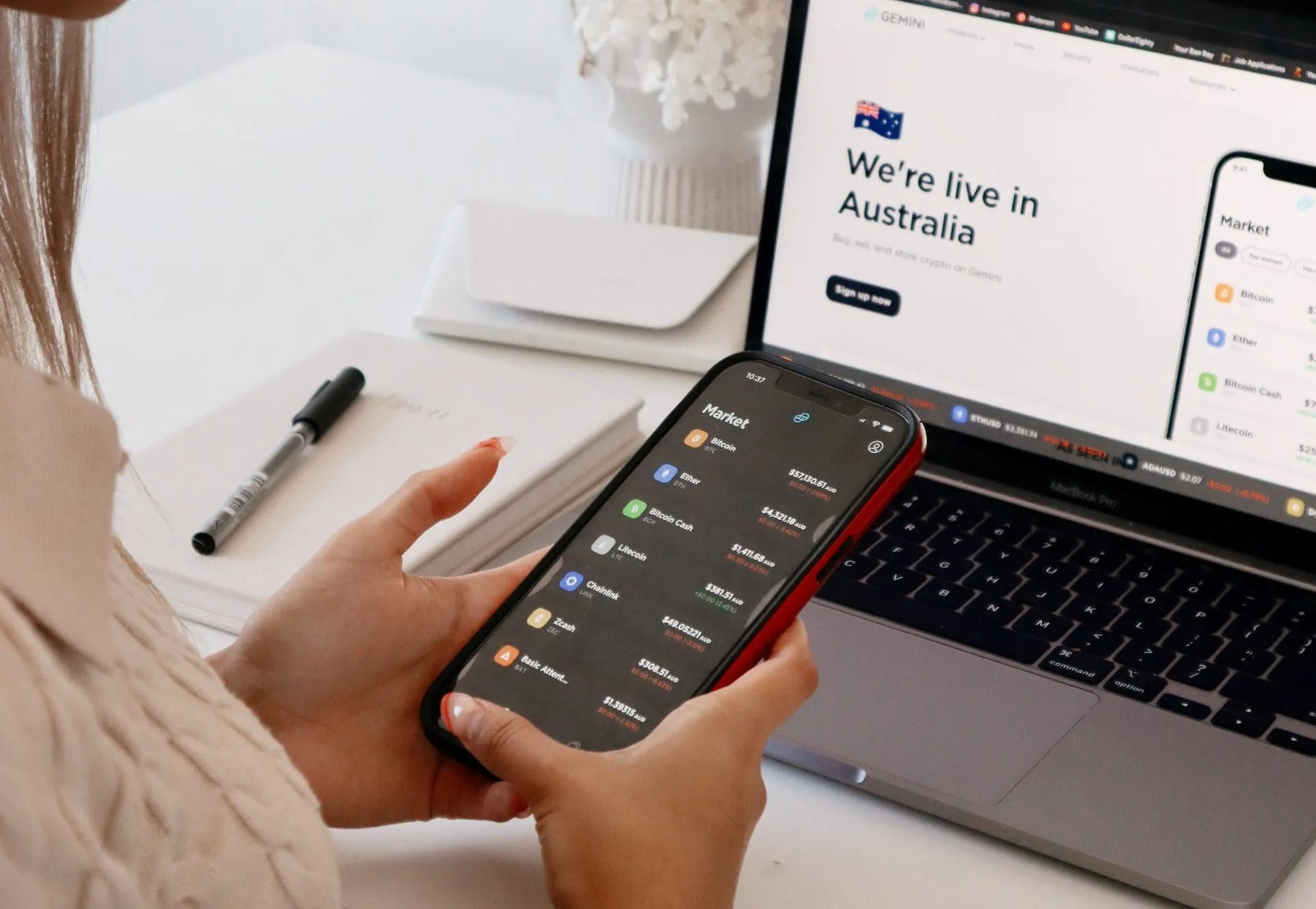 woman on phone and laptop in background