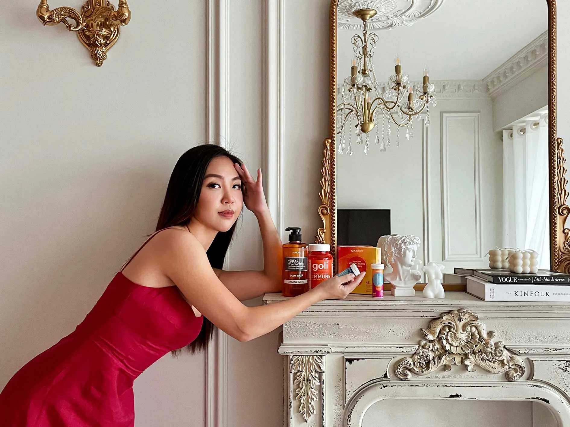 woman leaning on mantlepiece with makeup products