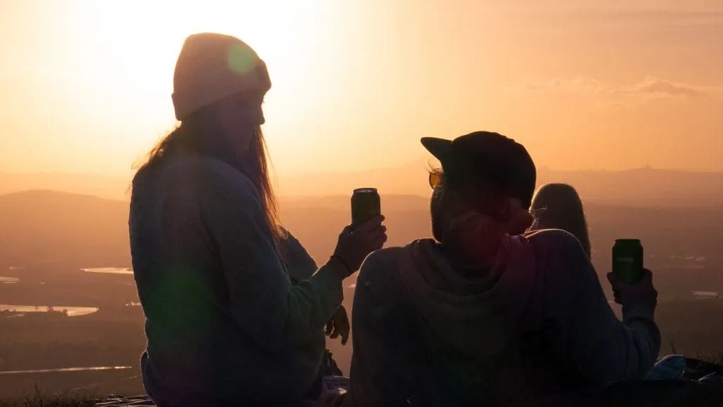couple watching sunset on cliff top