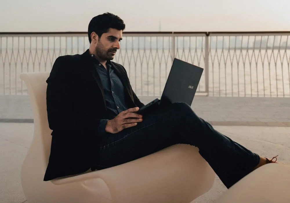 man on laptop on balcony