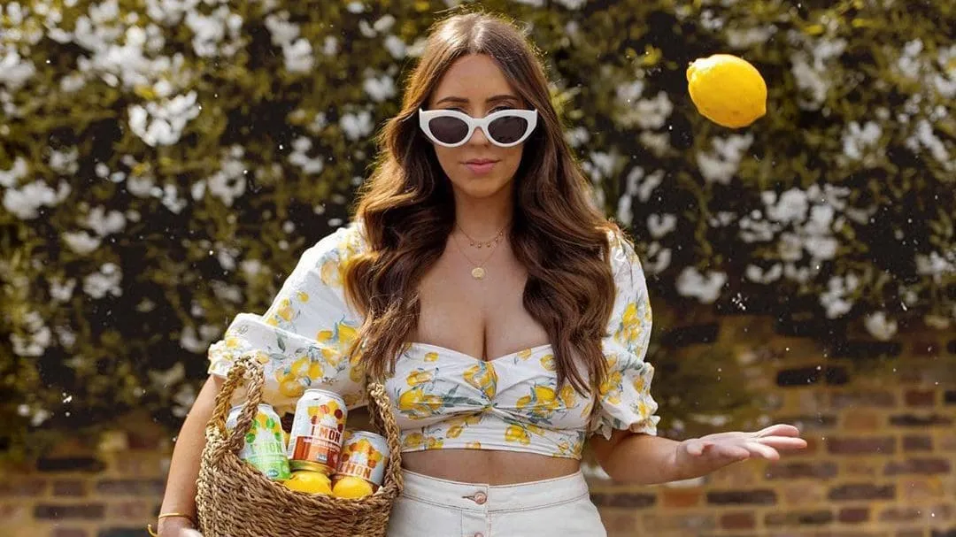 Woman holding a basket and tossing a lemon, styled for an Instagram content shoot