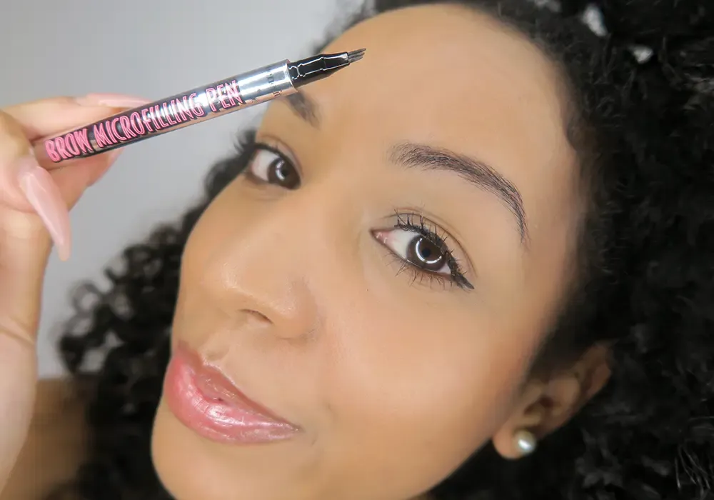 woman holding eyeliner to face
