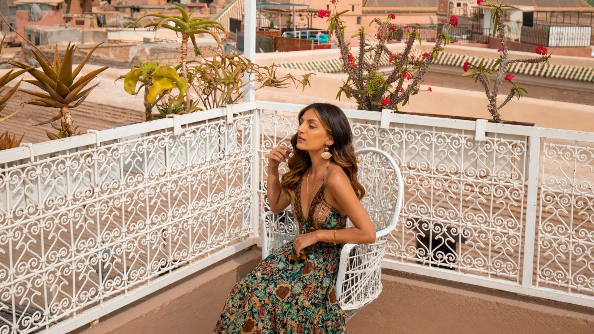 woman sitting on a white chair on a roof terrace nikitabathia flight centre