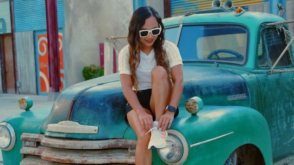 woman sitting on truck wearing activewear