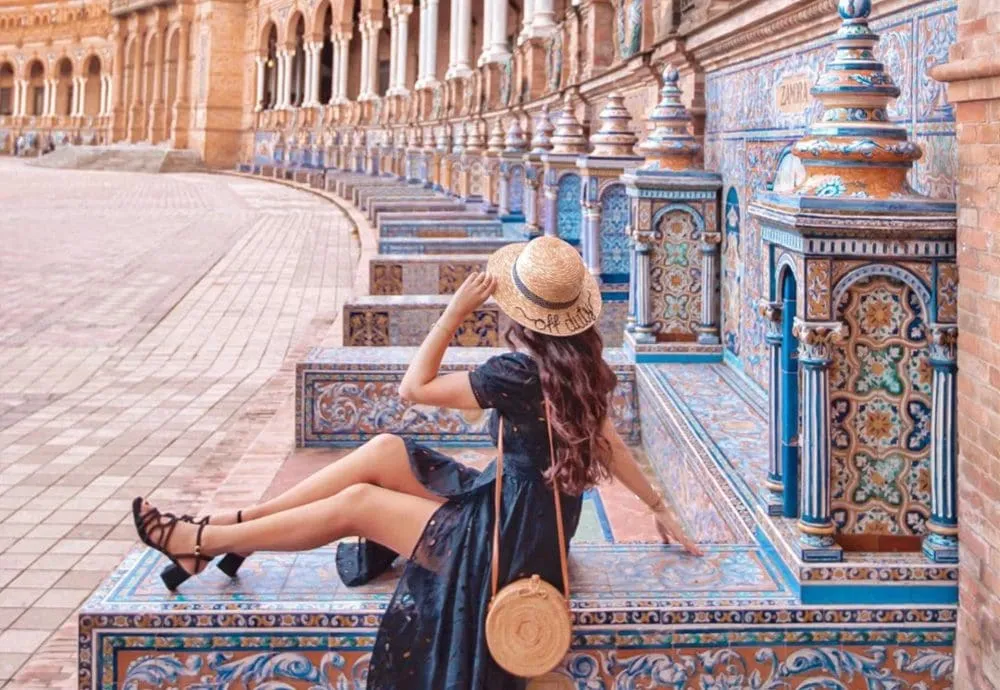 woman sitting on wall in straw hat anoushkalila @adobecreativecloud copy