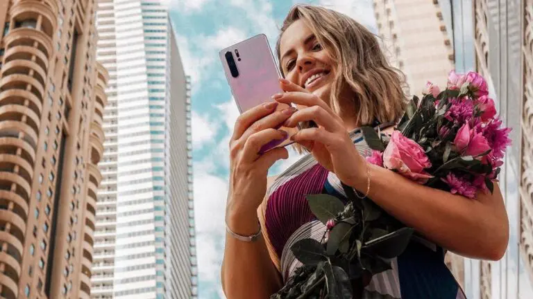 woman on phone with flowers in hand magdajano - Huawei