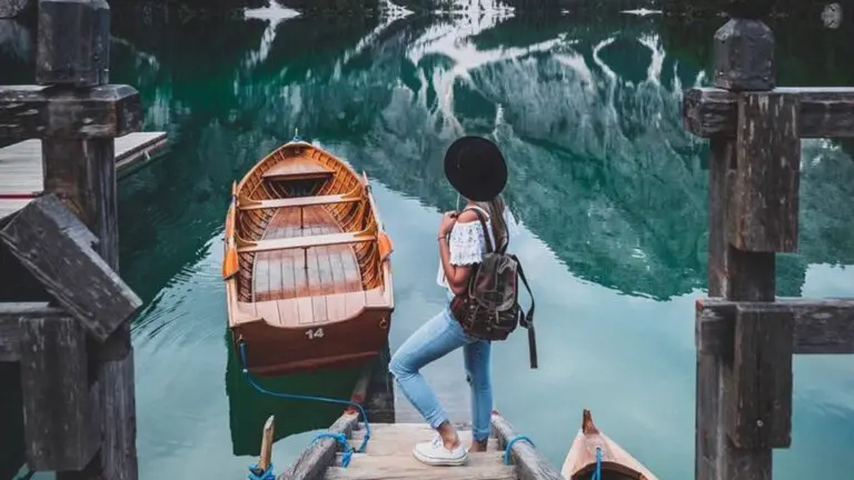 woman in front of boat on lake in mountains bettina___h @Adobe_DE