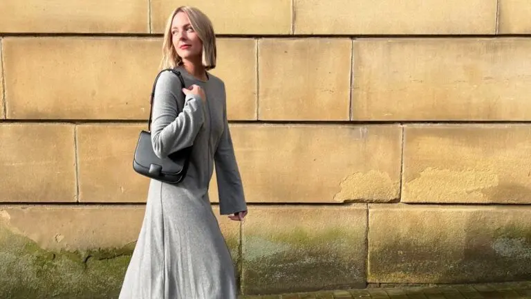 woman wearing grey dress with black bag