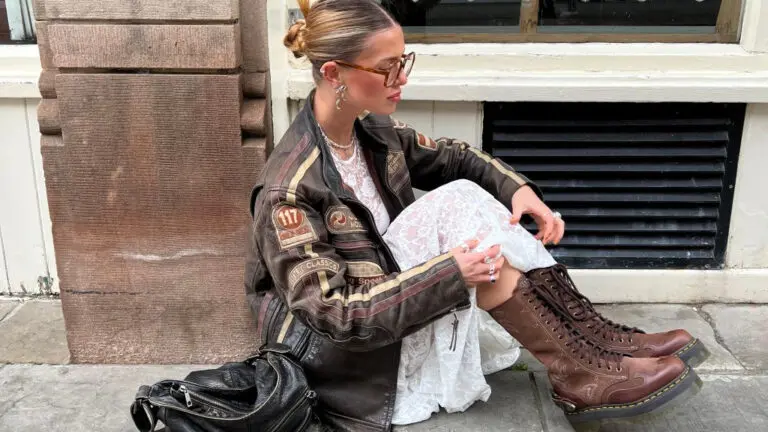 woman in leather jacket, white dress and boots