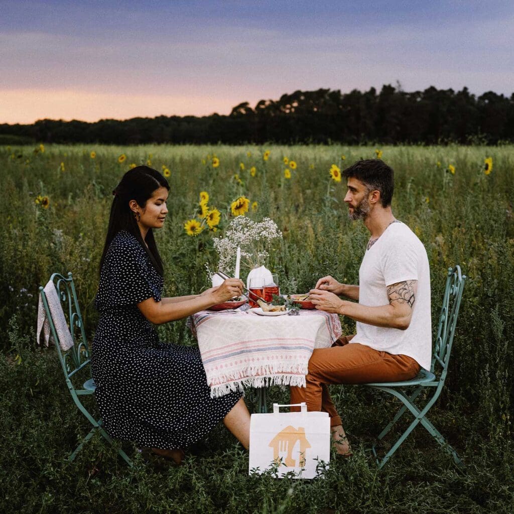 Couple sitting at a table in a field