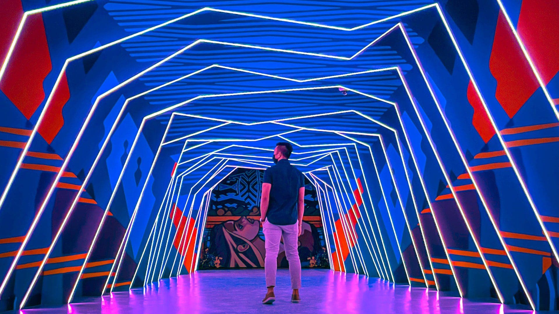man standing in multicoloured tunnel