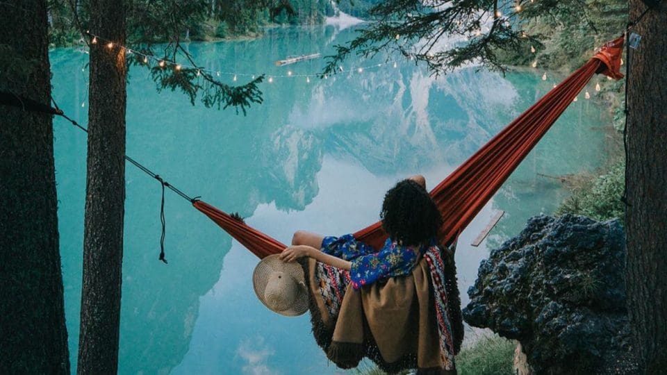 woman in hammock over lake