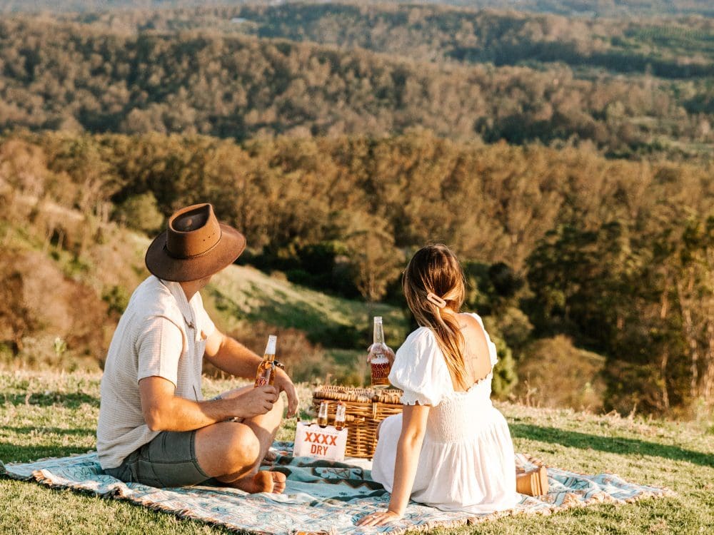 couple on grassy hill having picnic ashleydobson bws_au