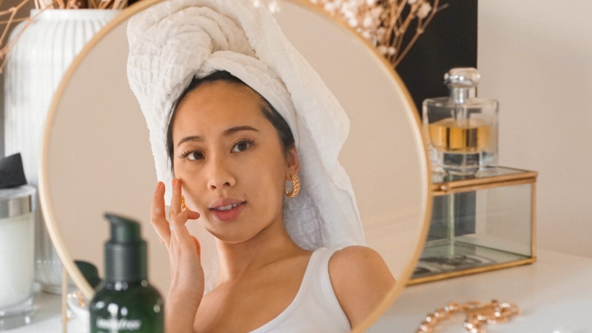 woman applying makeup in mirror