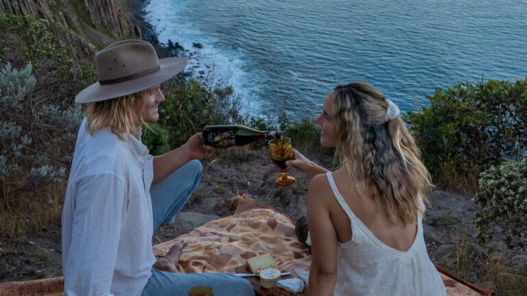 couple having picnic on cliff edge