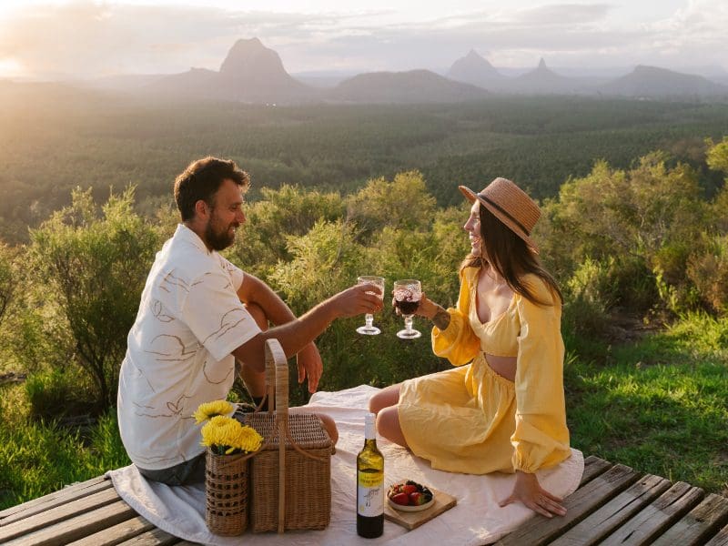 couple having picnic with mountain scape
