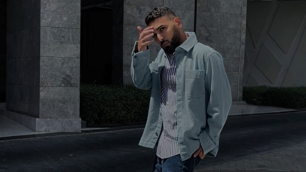 man in denim jacket and striped shirt