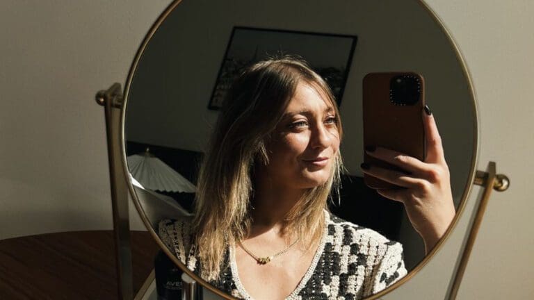 woman taking selfie in circle mirror