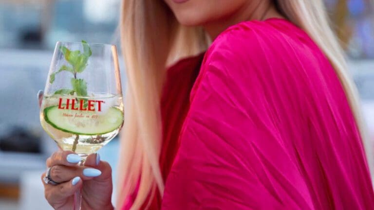 woman holding lillet wine glass