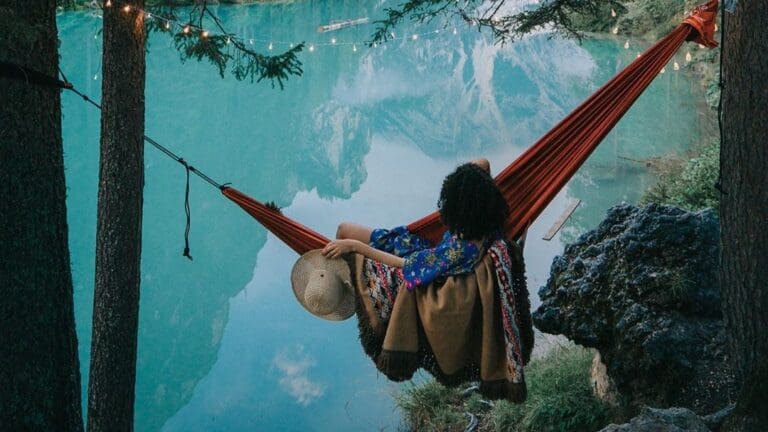 woman in hammock looking out to lake