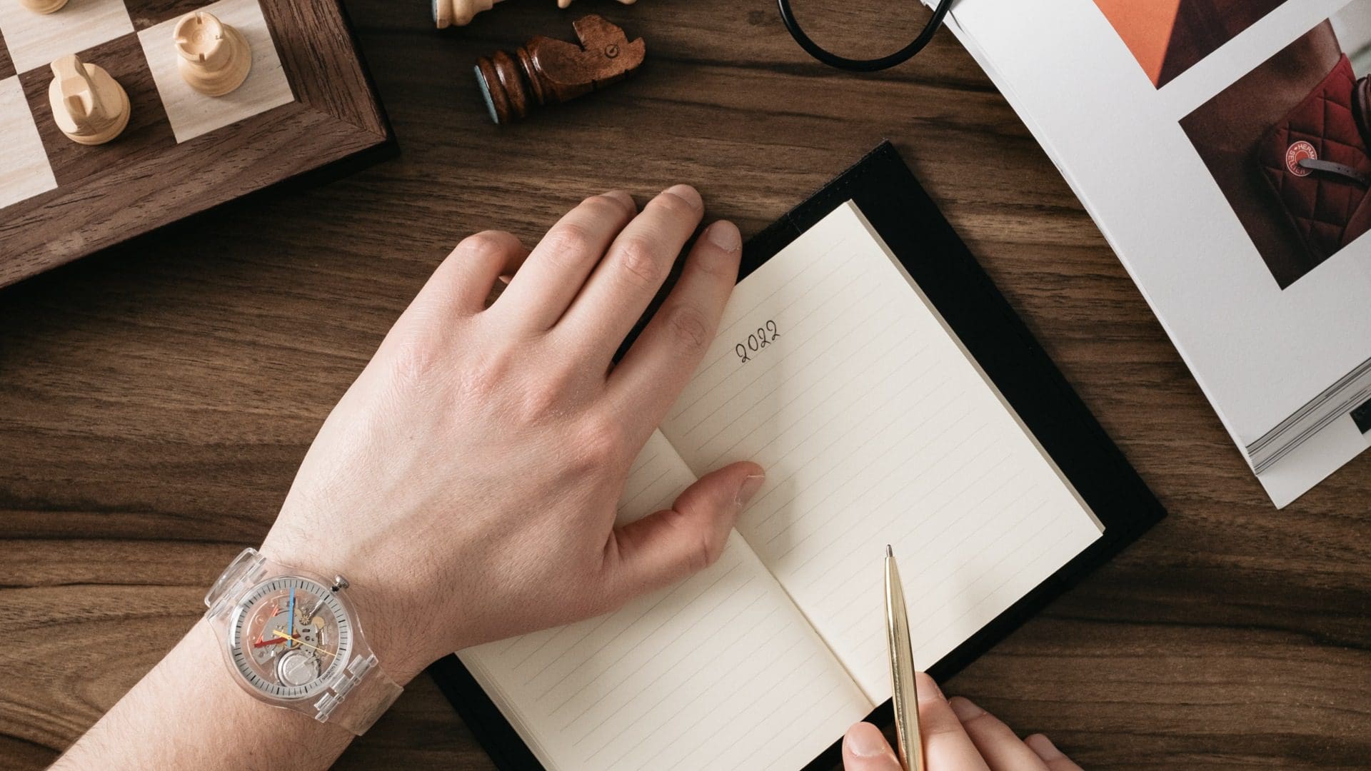 birds eye view of mans hand with notebook