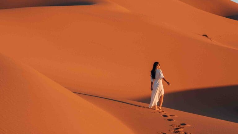 woman in desert on sand dune
