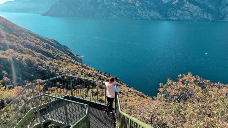 woman looking out to mountainous lake view