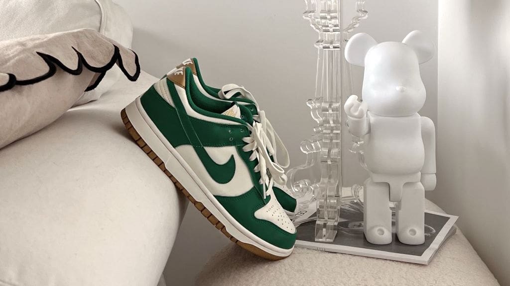 pair of green nike air force ones perched on sofa