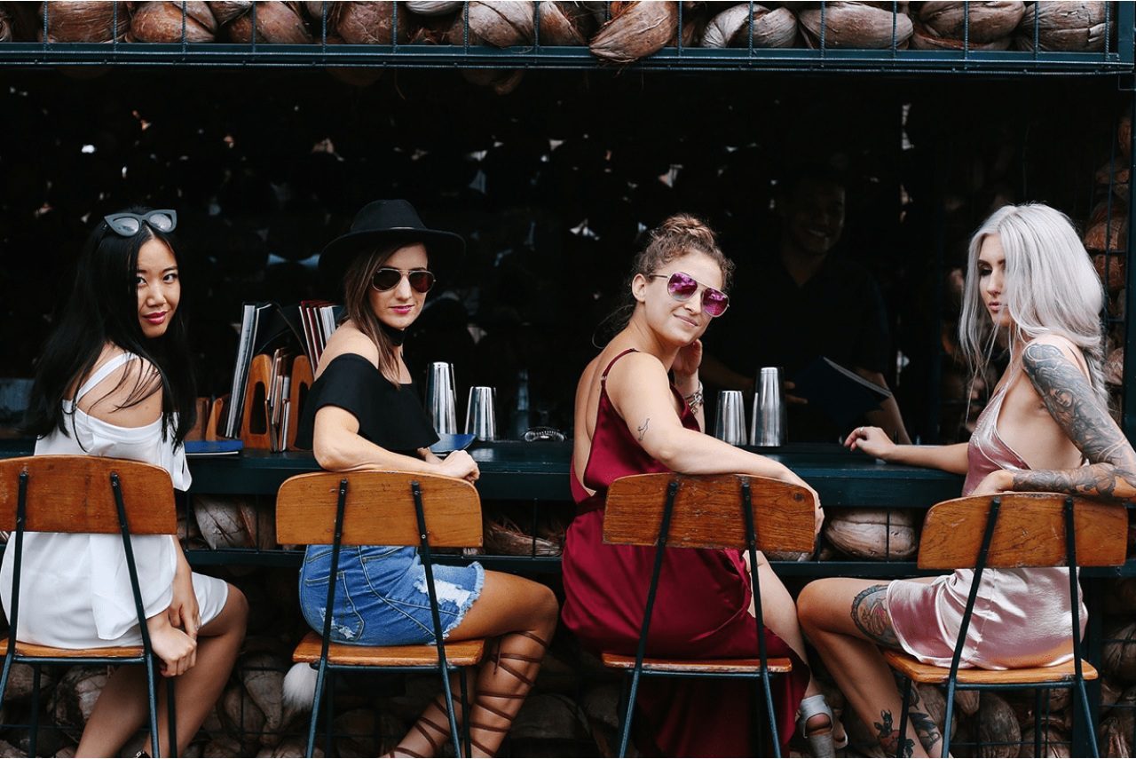 four women at a bar